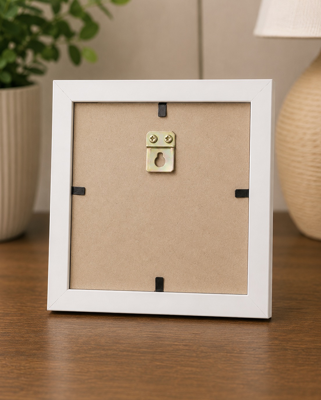 Back of white photo frame showing the rear hanging clip